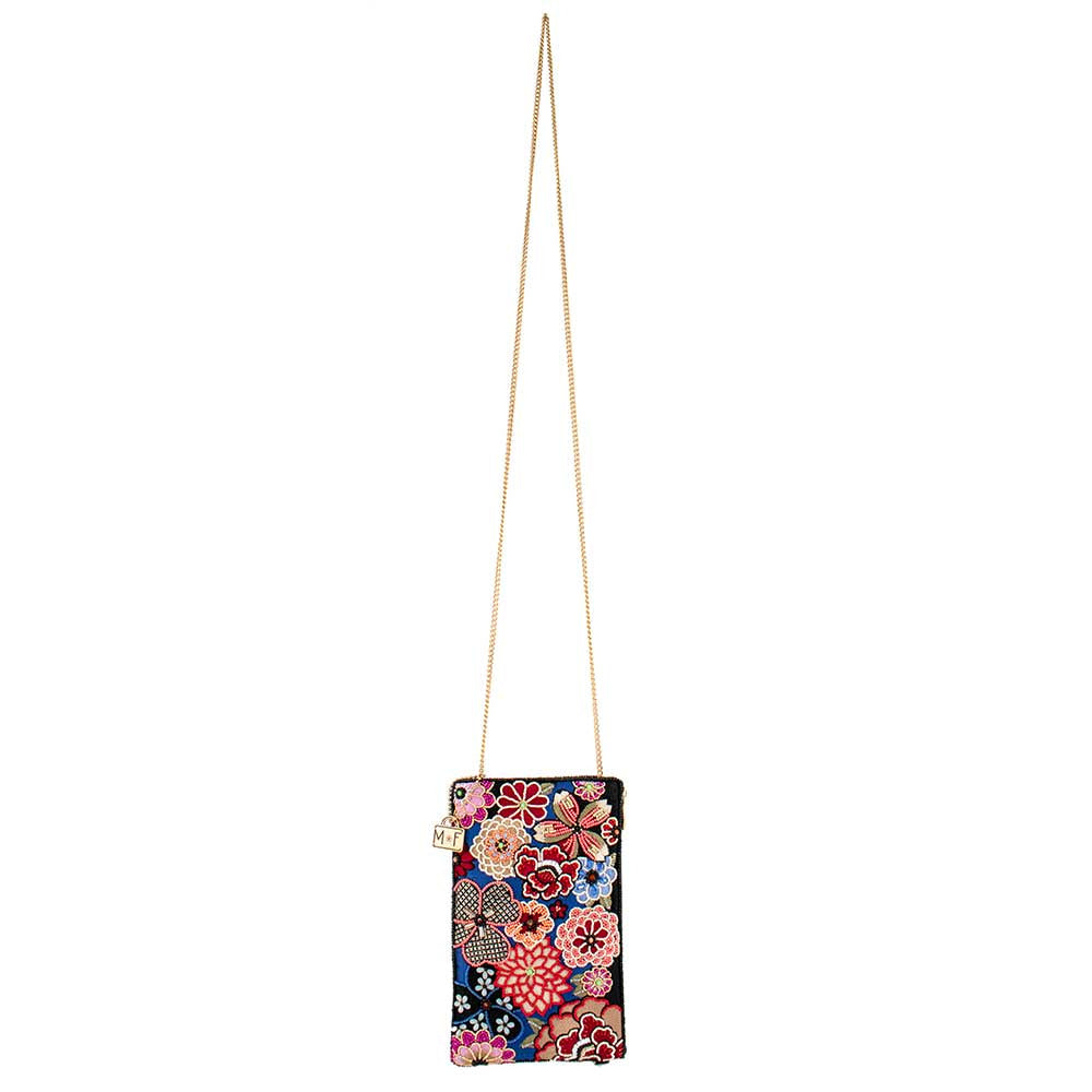 Floral embroidered clutch purse with a gold chain strap.