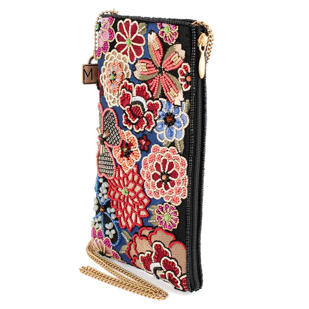 Ornate floral embroidered clutch purse with a zipper and gold chain strap.