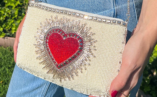 Model waering Follow Your Heart beaded mini crossbody clutch peruse